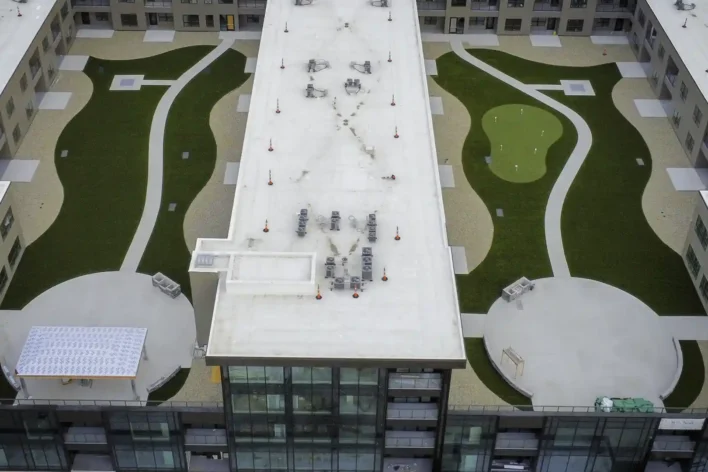 Aerial view of two custom-shaped rooftop putting greens on a commercial office building in Fort Wayne, Indiana